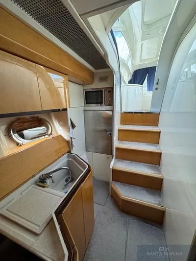  Yacht Photos Pics Interior of 2006 Cantieri di Sarnico 60 yacht with kitchenette and stairs.