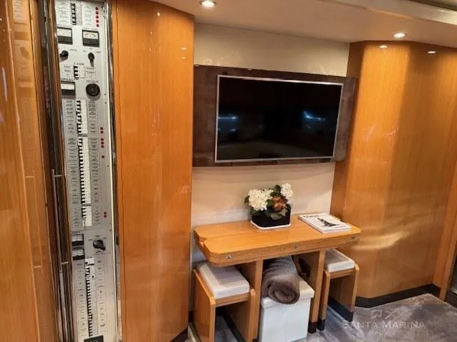  Yacht Photos Pics Luxurious interior of 2006 Cantieri di Sarnico 60 yacht with TV and wooden decor.