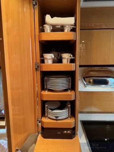  Yacht Photos Pics Wooden cabinet with neatly arranged dishes and cups on a 2006 Cantieri di Sarnico 60 yacht.