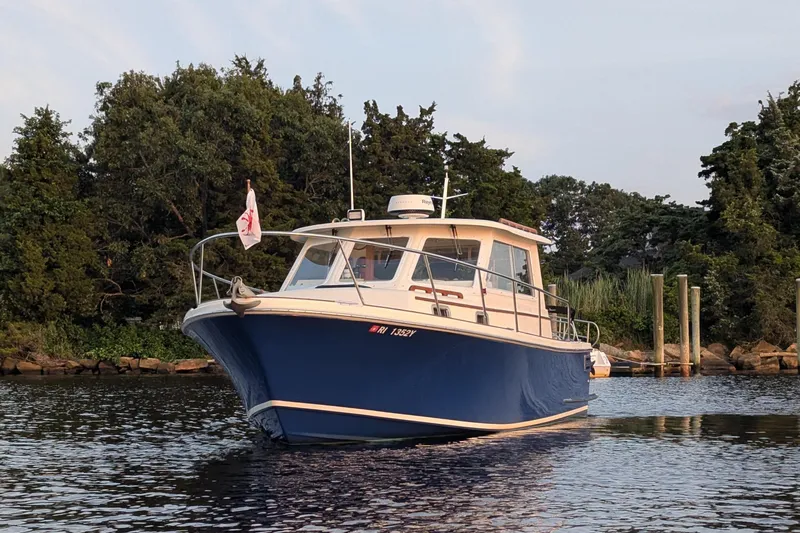  Yacht Photos Pics Hunt Yachts 28 Express 2000 model on calm water near a wooded shoreline.