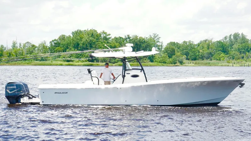  Yacht Photos Pics 2014 Regulator 34 boat on water with Yamaha engine, surrounded by trees.