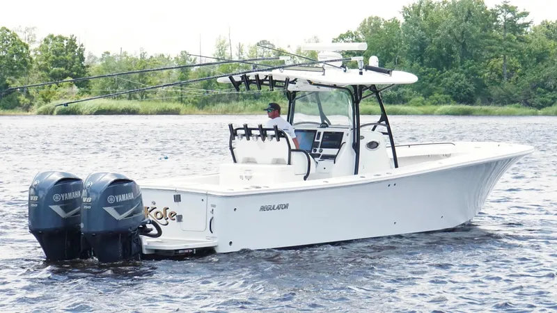  Yacht Photos Pics 2014 Regulator 34 boat with dual Yamaha engines on a calm lake.