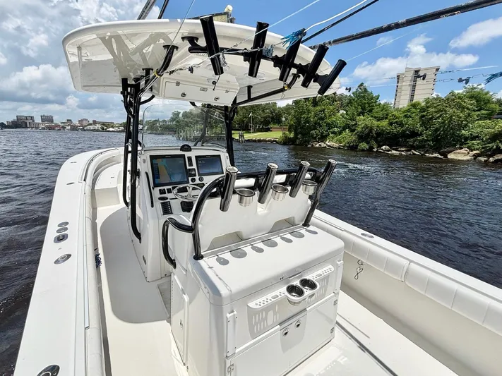  Yacht Photos Pics 2014 Regulator 34 boat interior with control panel and rod holders on a sunny day.