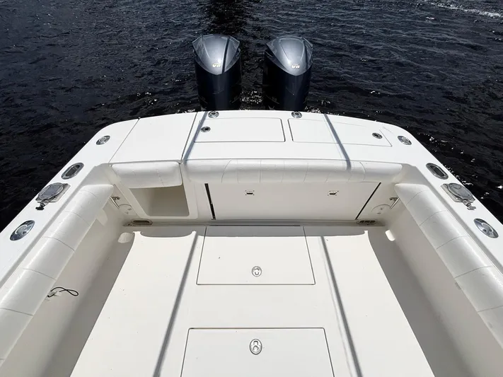  Yacht Photos Pics 2014 Regulator 34 boat deck with twin outboard engines on water.