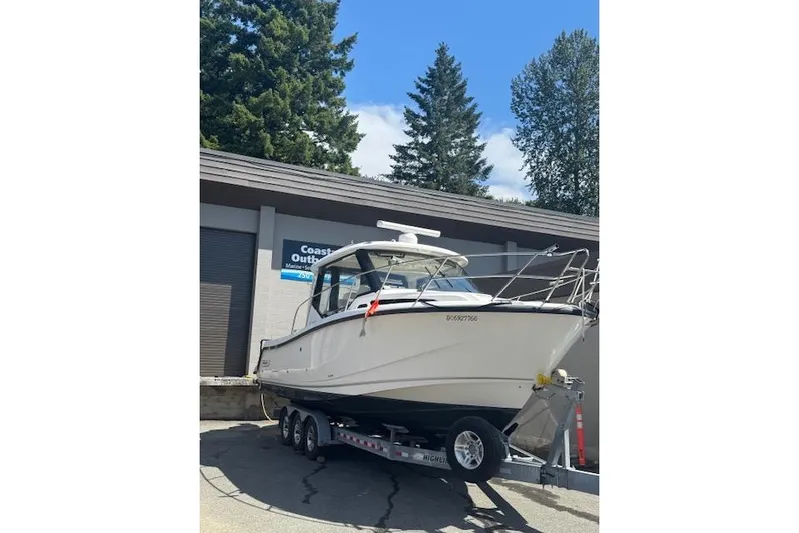  Yacht Photos Pics 2020 Boston Whaler 325 Conquest boat on trailer, parked outdoors.