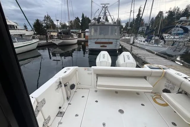  Yacht Photos Pics 2020 Boston Whaler 325 Conquest docked at a marina with other boats.