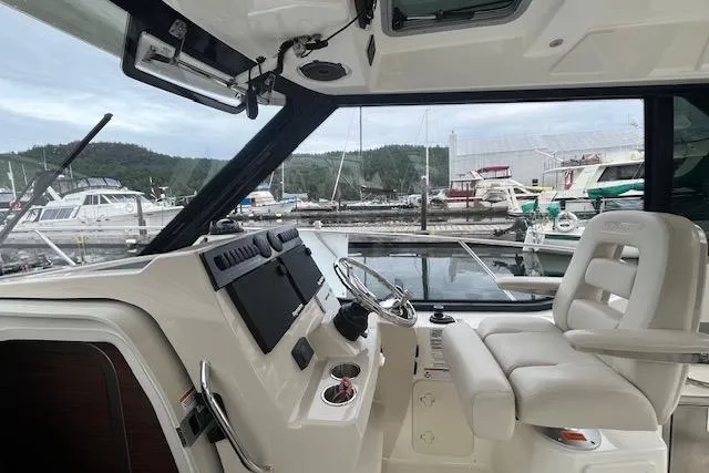  Yacht Photos Pics 2020 Boston Whaler 325 Conquest helm with marina view in the background.
