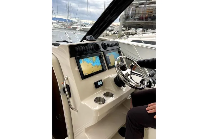  Yacht Photos Pics Helm of 2020 Boston Whaler 325 Conquest with dual navigation screens and steering wheel.