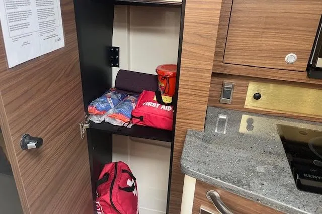  Yacht Photos Pics Interior of 2020 Boston Whaler 325 Conquest with first aid kit and supplies in cabinet.