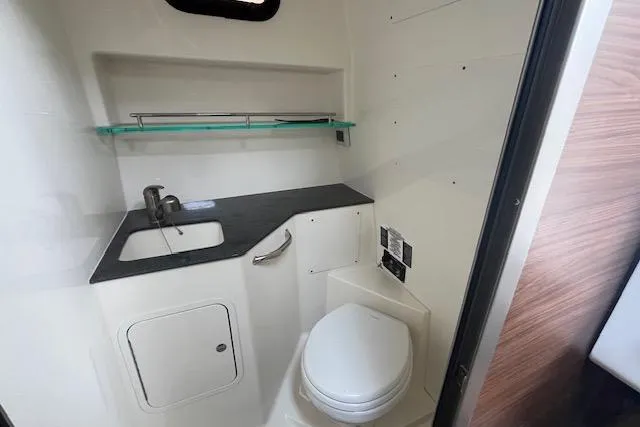  Yacht Photos Pics 2020 Boston Whaler 325 Conquest boat bathroom with sink, toilet, and storage.