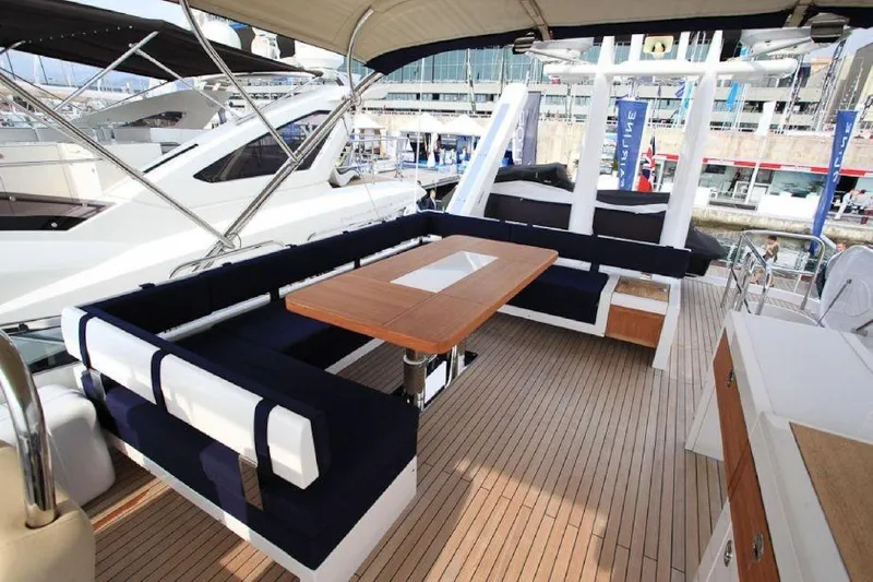 Gala Yacht Photos Pics Luxurious 2012 Fsirline Squadron 78 yacht deck with elegant seating and wooden table.