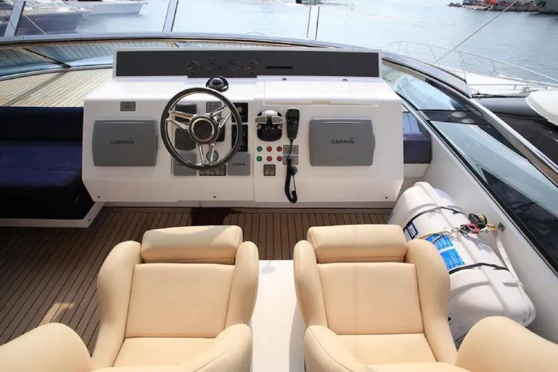 Gala Yacht Photos Pics Luxurious helm of 2012 Fsirline Squadron 78 yacht with modern controls and seating.