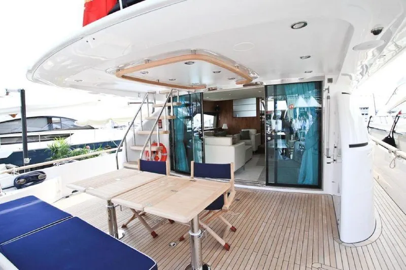 Gala Yacht Photos Pics Luxury yacht deck with seating, table, and sliding glass doors; Fsirline Squadron 78, 2012 model.