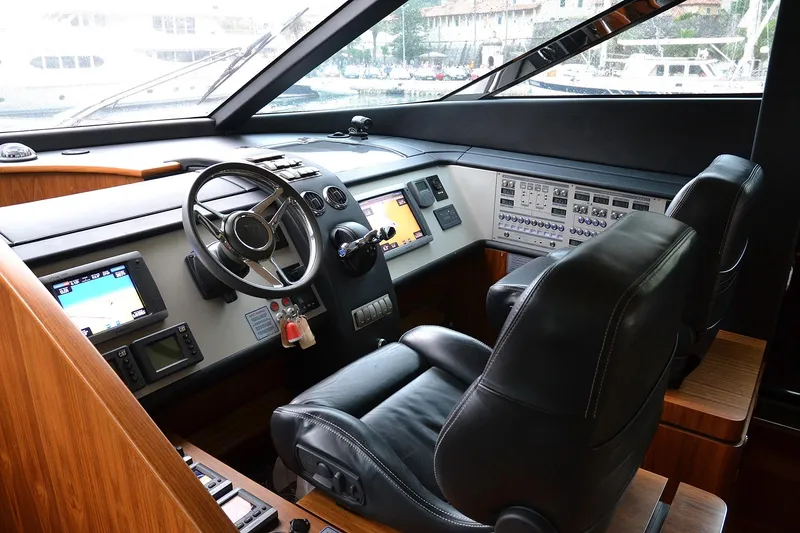 Gala Yacht Photos Pics Luxurious 2012 Fsirline Squadron 78 yacht cockpit with advanced navigation controls and leather seating.