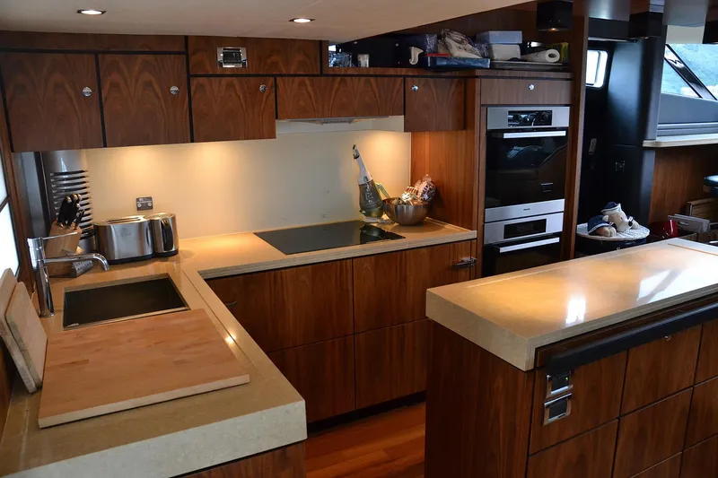 Gala Yacht Photos Pics Luxurious kitchen interior of 2012 Fsirline Squadron 78 yacht with modern appliances.