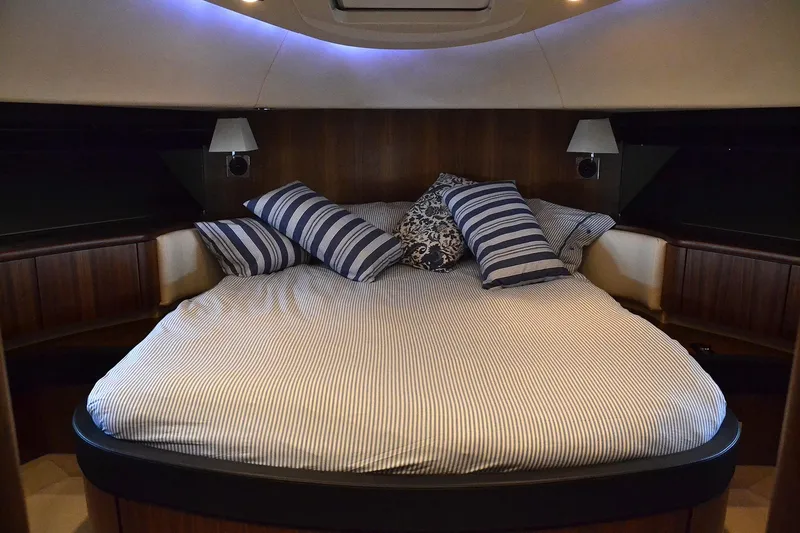 Gala Yacht Photos Pics Luxurious cabin interior of 2012 Fsirline Squadron 78 yacht with cozy bedding.