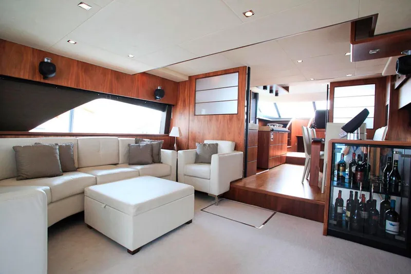 Gala Yacht Photos Pics Luxurious interior of 2012 Fsirline Squadron 78 yacht with elegant seating and wine display.