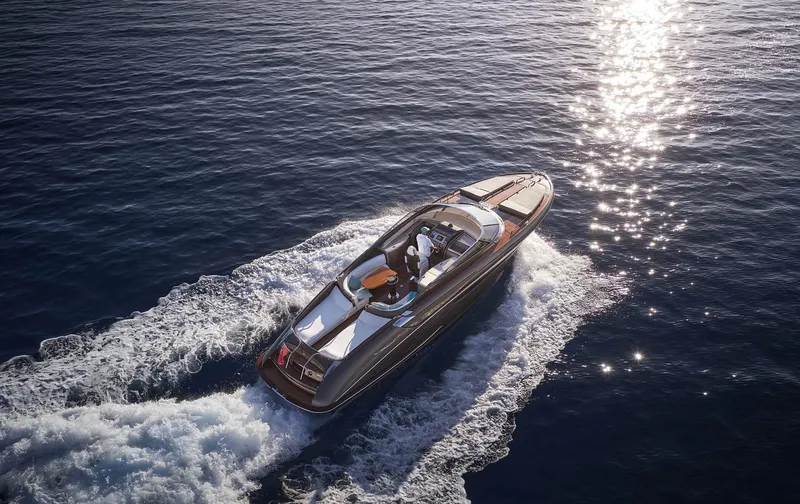  Yacht Photos Pics 2014 Riva Rivarama Super 44 yacht cruising on sparkling blue water.