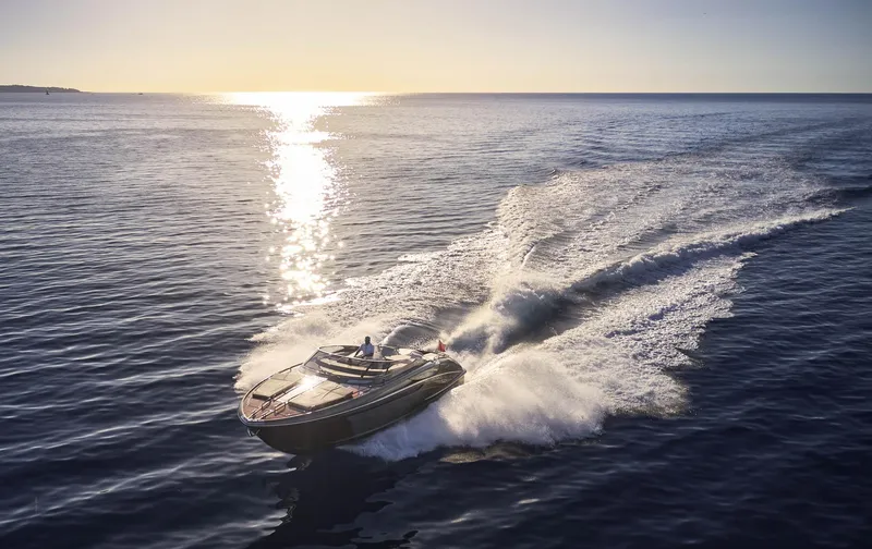  Yacht Photos Pics 2014 Riva Rivarama Super 44 yacht cruising on open sea at sunset.
