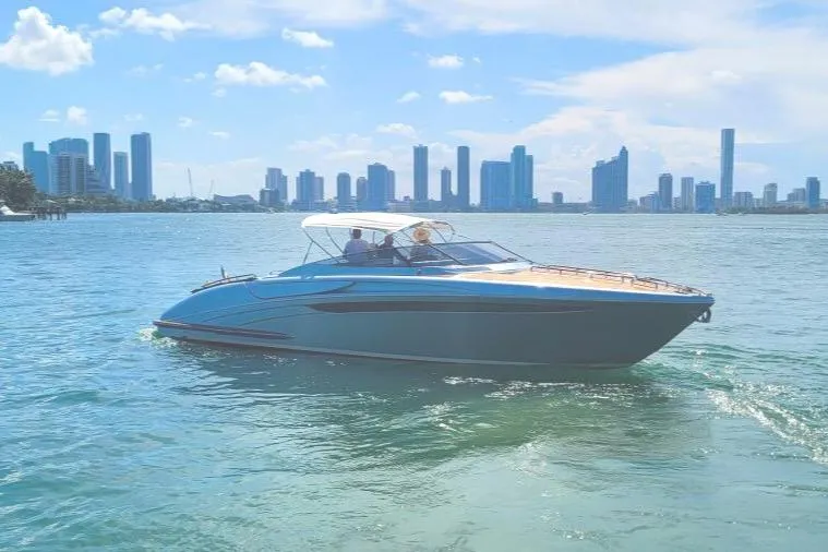  Yacht Photos Pics 2014 Riva Rivarama Super 44 yacht cruising near city skyline on a sunny day.