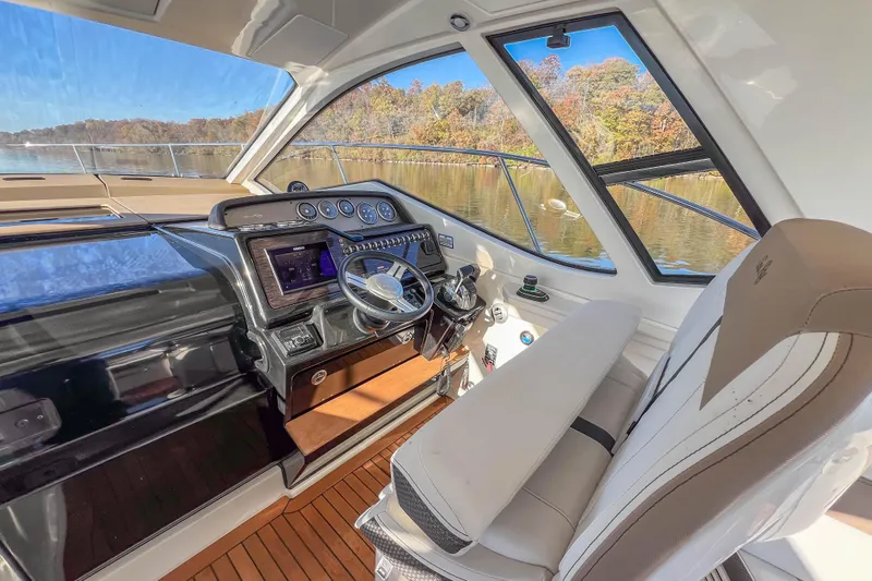  Yacht Photos Pics Interior of 2018 Sea Ray Sundancer 350 Coupe, featuring helm and luxurious seating.