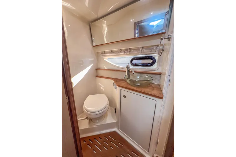  Yacht Photos Pics Luxurious bathroom in 2018 Sea Ray Sundancer 350 Coupe with modern fixtures and wood accents.