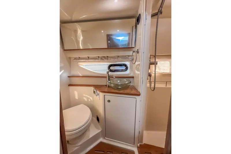  Yacht Photos Pics 2018 Sea Ray Sundancer 350 Coupe bathroom with modern fixtures and wood accents.