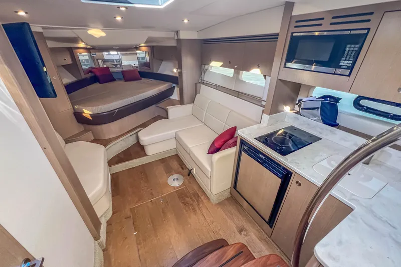  Yacht Photos Pics Interior of 2018 Sea Ray Sundancer 350 Coupe with modern kitchen and cozy seating area.