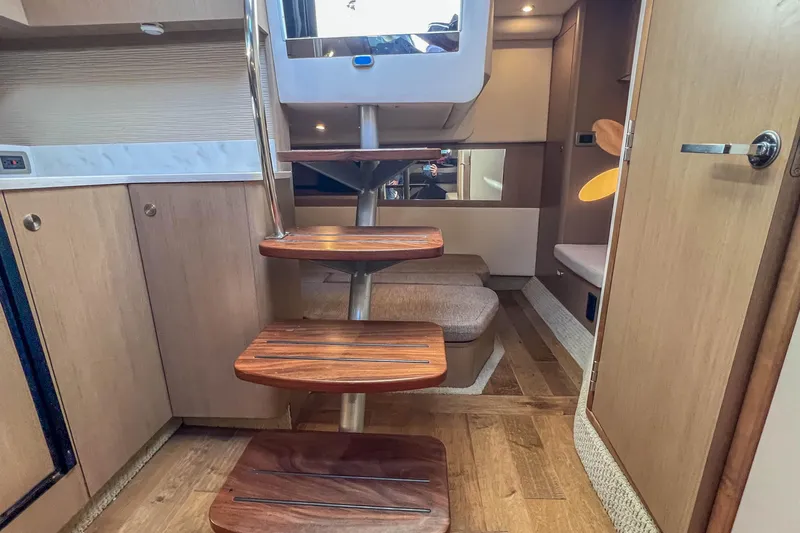  Yacht Photos Pics Interior of 2018 Sea Ray Sundancer 350 Coupe with wooden steps and modern design.