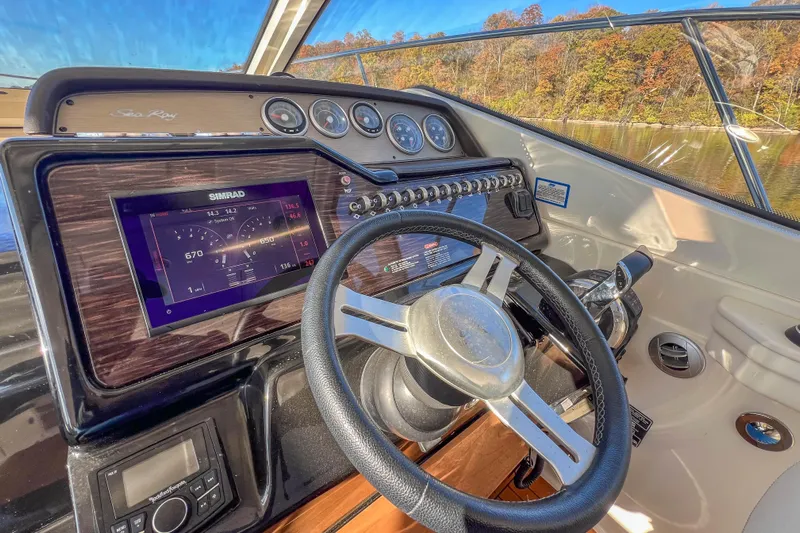  Yacht Photos Pics 2018 Sea Ray Sundancer 350 Coupe helm with modern navigation system and scenic lake view.