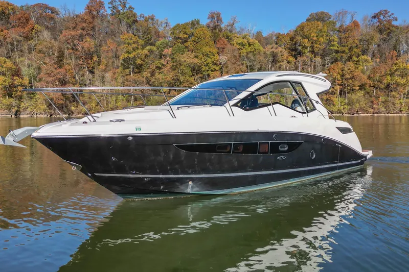  Yacht Photos Pics 2018 Sea Ray Sundancer 350 Coupe cruising on a calm lake with autumn foliage.
