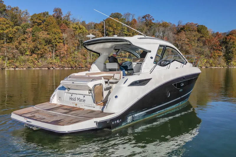  Yacht Photos Pics 2018 Sea Ray Sundancer 350 Coupe on calm water, surrounded by autumn trees.
