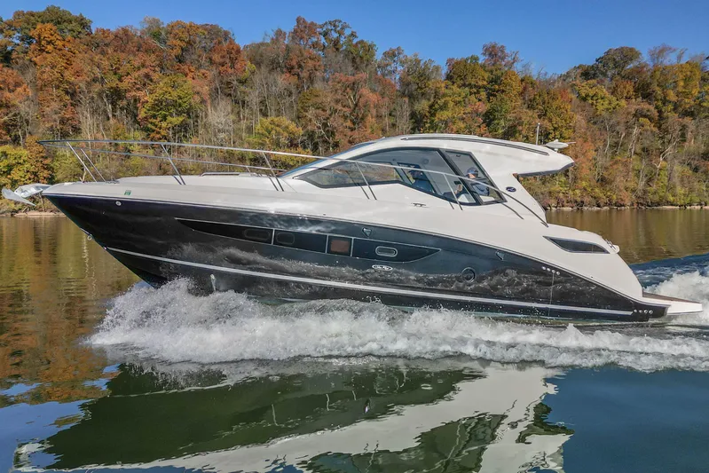  Yacht Photos Pics 2018 Sea Ray Sundancer 350 Coupe cruising on a scenic lake with autumn foliage.