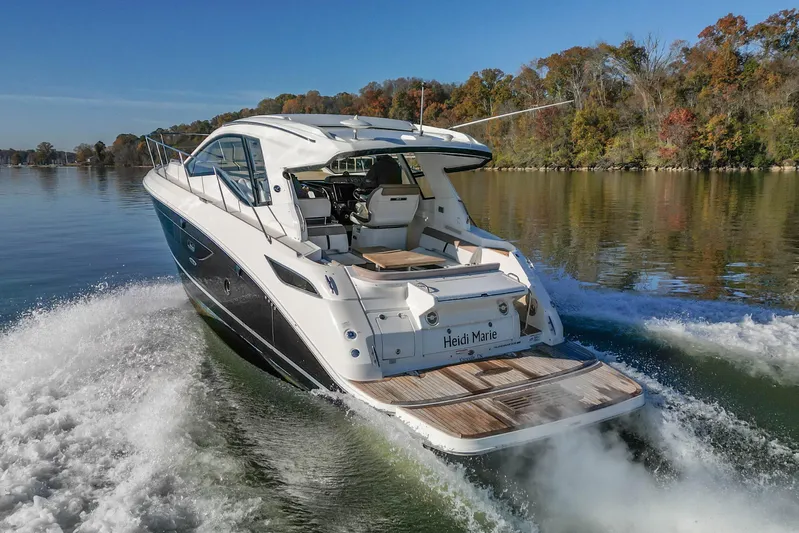  Yacht Photos Pics 2018 Sea Ray Sundancer 350 Coupe cruising on a serene lake with autumn foliage.