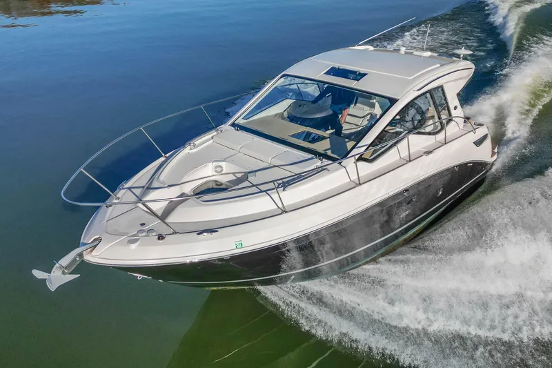  Yacht Photos Pics 2018 Sea Ray Sundancer 350 Coupe cruising on calm water, showcasing sleek design and performance.