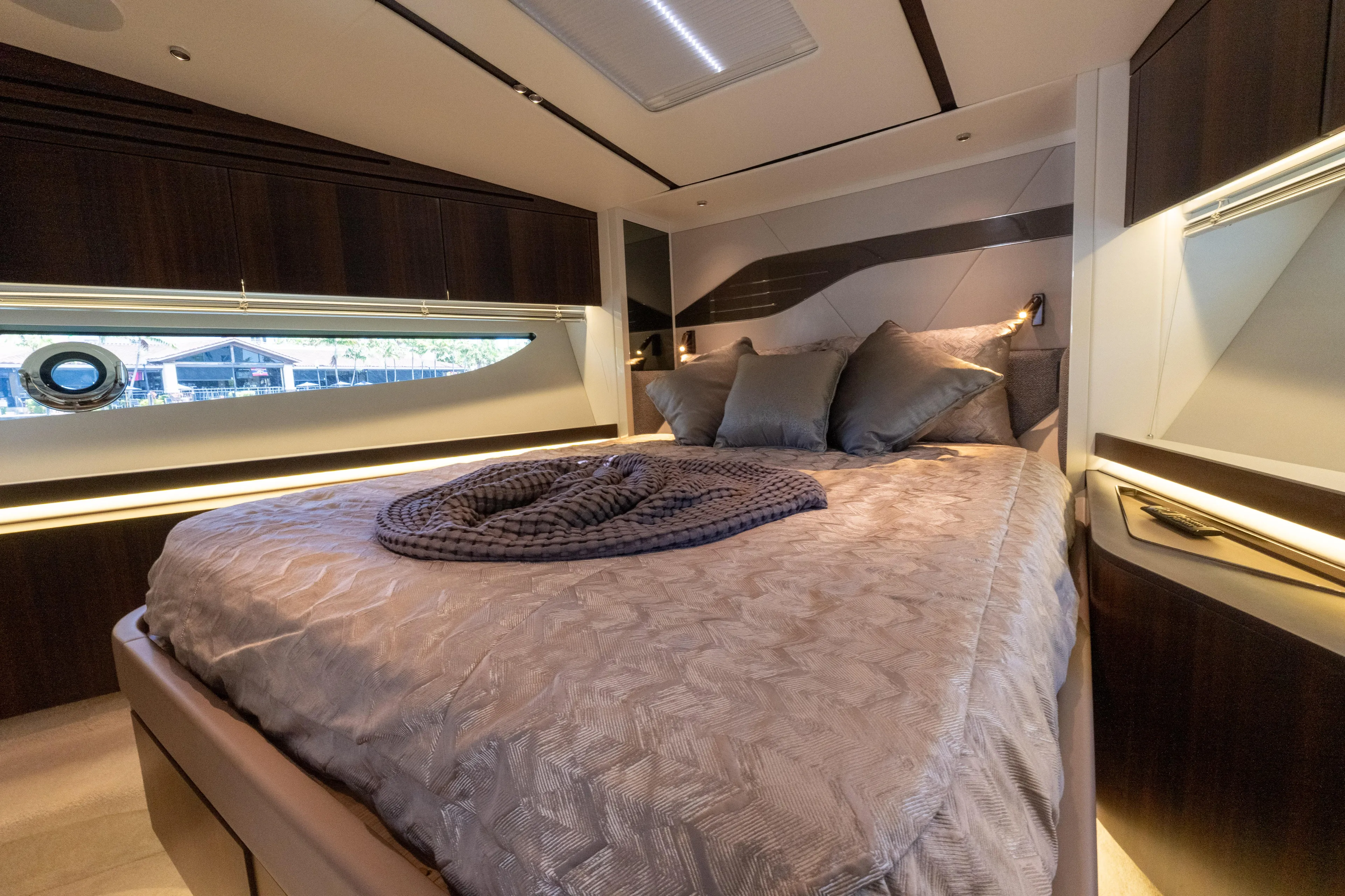 Brew Crew Yacht Photos Pics Luxurious bedroom interior of 2022 Sunseeker Predator 60 yacht with elegant bedding and modern design.