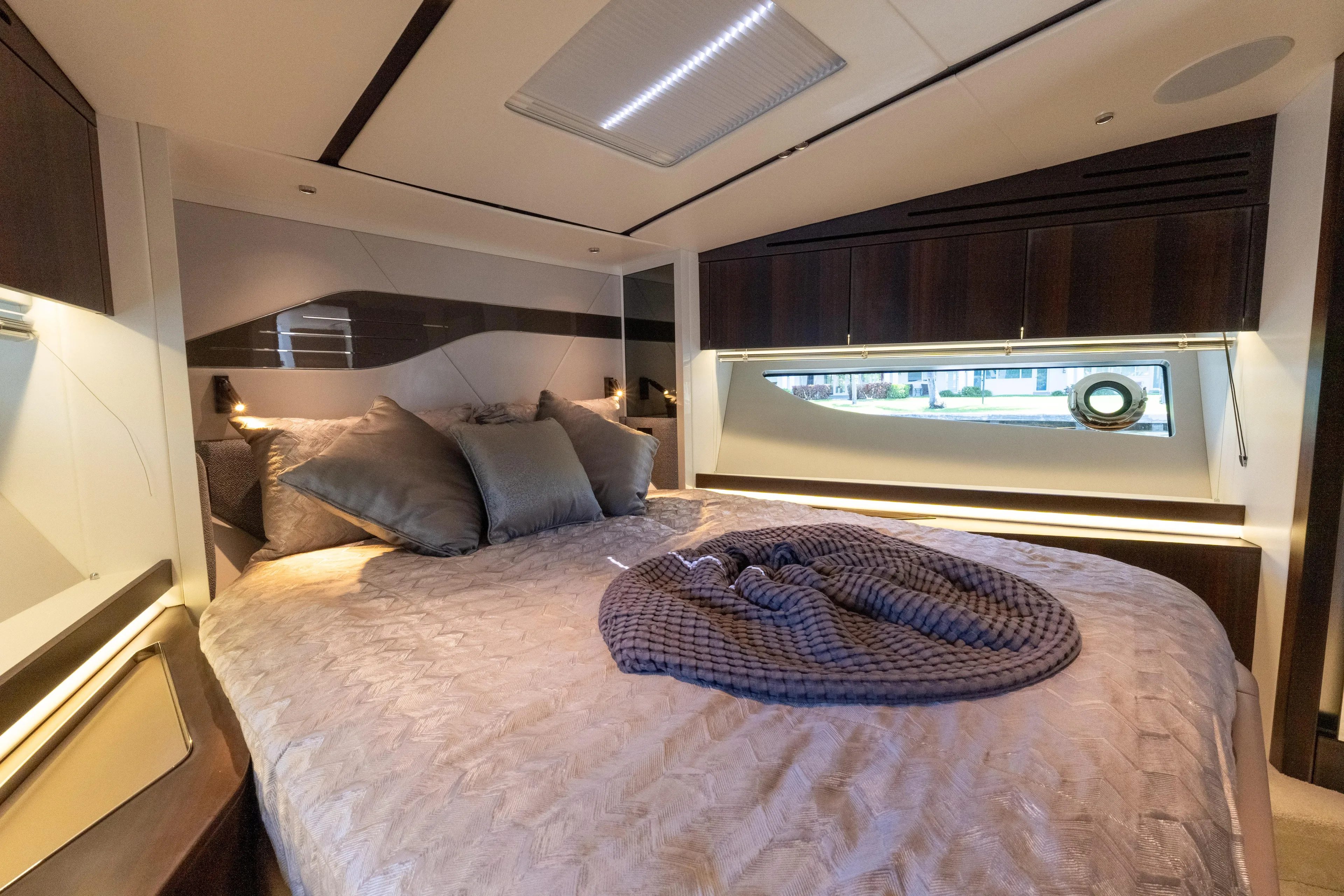 Brew Crew Yacht Photos Pics Luxurious bedroom interior of 2022 Sunseeker Predator 60 yacht with elegant bedding and modern design.