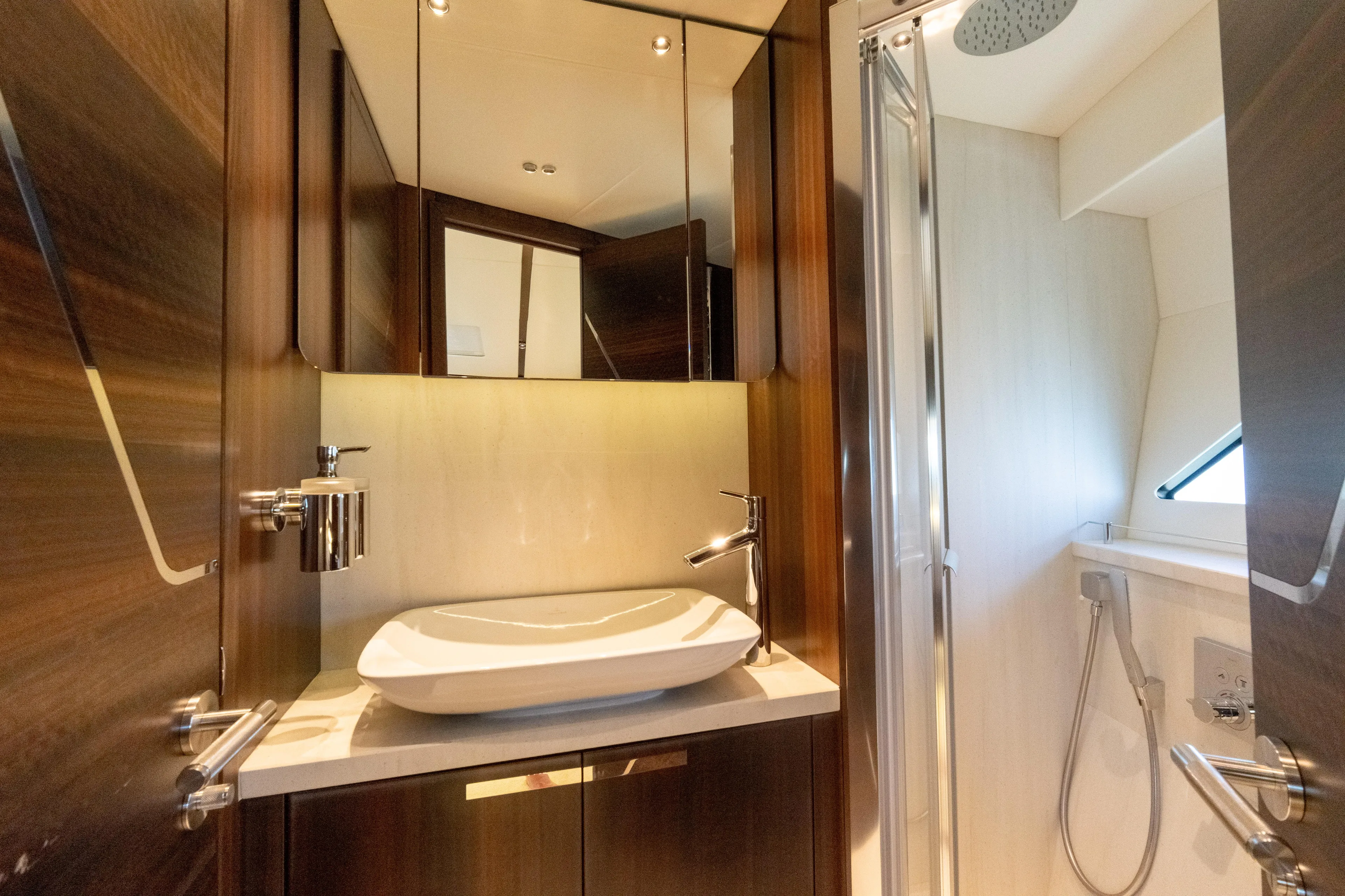 Brew Crew Yacht Photos Pics Luxurious bathroom in 2022 Sunseeker Predator 60 yacht with modern fixtures and elegant design.