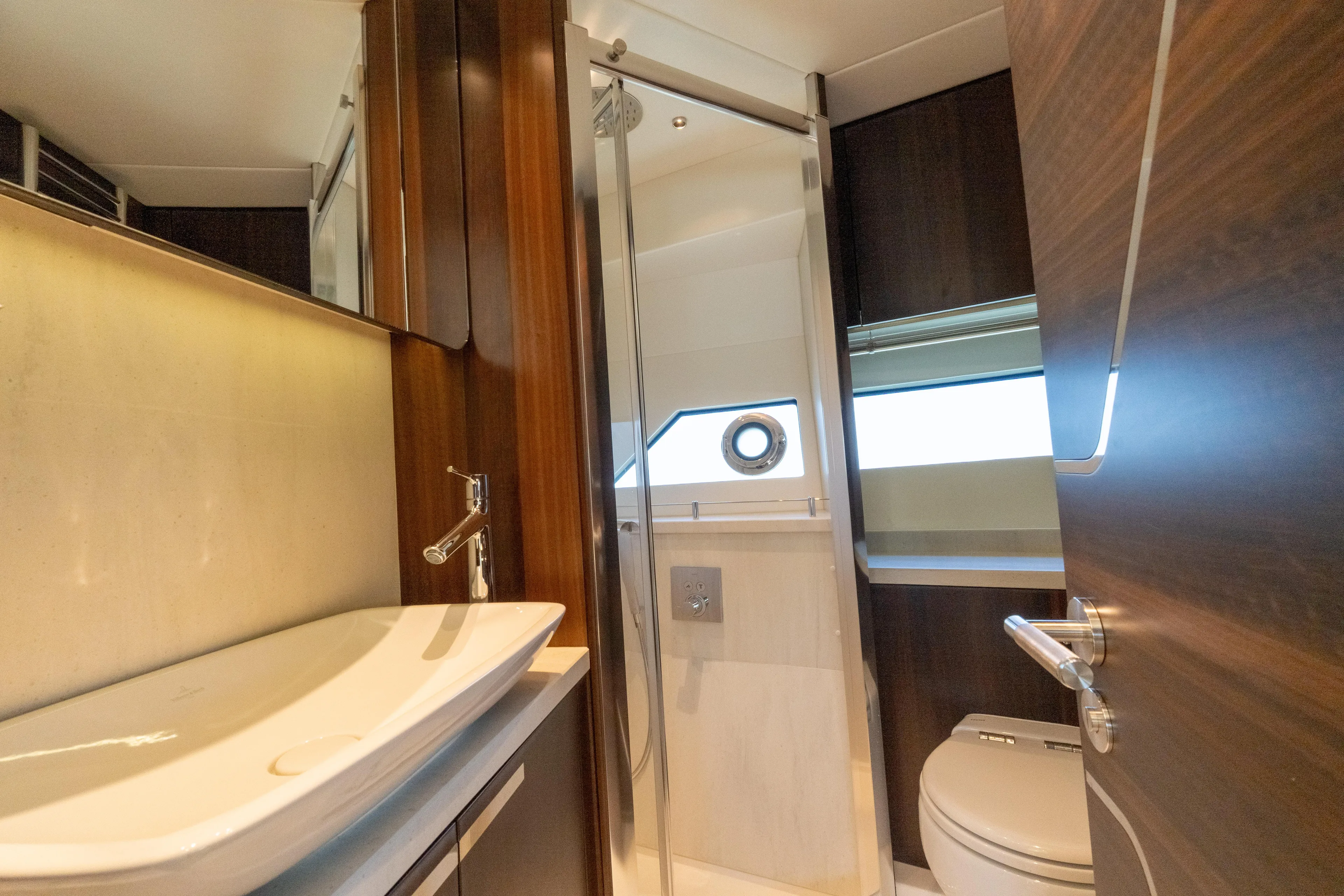 Brew Crew Yacht Photos Pics Luxurious bathroom in 2022 Sunseeker Predator 60 yacht, featuring modern fixtures and elegant design.