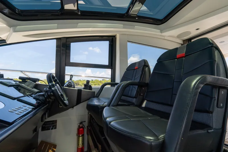 Brew Crew Yacht Photos Pics Interior of 2022 Sunseeker Predator 60 yacht cockpit with leather seats and steering wheel.