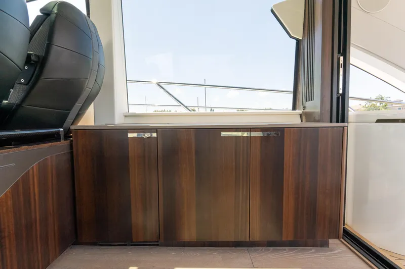 Brew Crew Yacht Photos Pics Interior of 2022 Sunseeker Predator 60 yacht, featuring sleek wooden cabinetry.