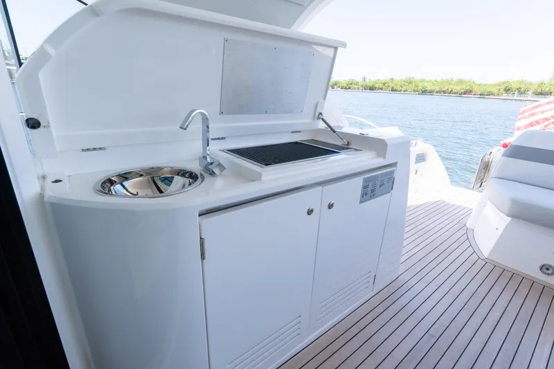 Brew Crew Yacht Photos Pics Outdoor kitchenette on 2022 Sunseeker Predator 60 yacht, featuring sink and grill.