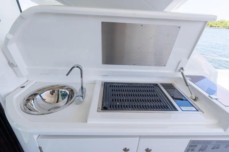 Brew Crew Yacht Photos Pics Outdoor kitchen on 2022 Sunseeker Predator 60 yacht with sink and grill.