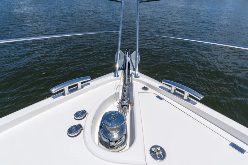 Brew Crew Yacht Photos Pics Bow of 2022 Sunseeker Predator 60 yacht with anchor and railing, on water.
