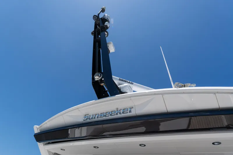 Brew Crew Yacht Photos Pics 2022 Sunseeker Predator 60 yacht, sleek design under clear blue sky.