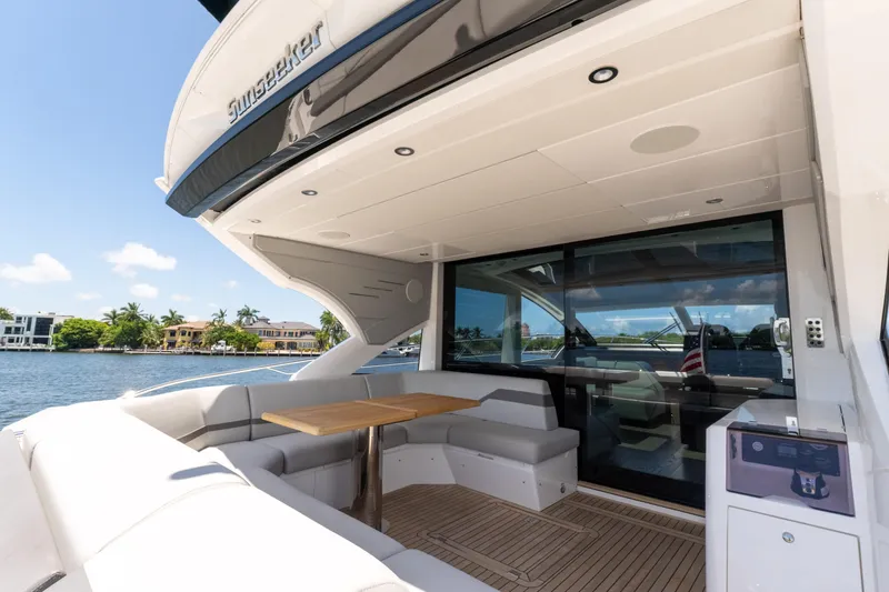 Brew Crew Yacht Photos Pics Luxurious 2022 Sunseeker Predator 60 yacht with spacious outdoor seating and scenic waterfront view.
