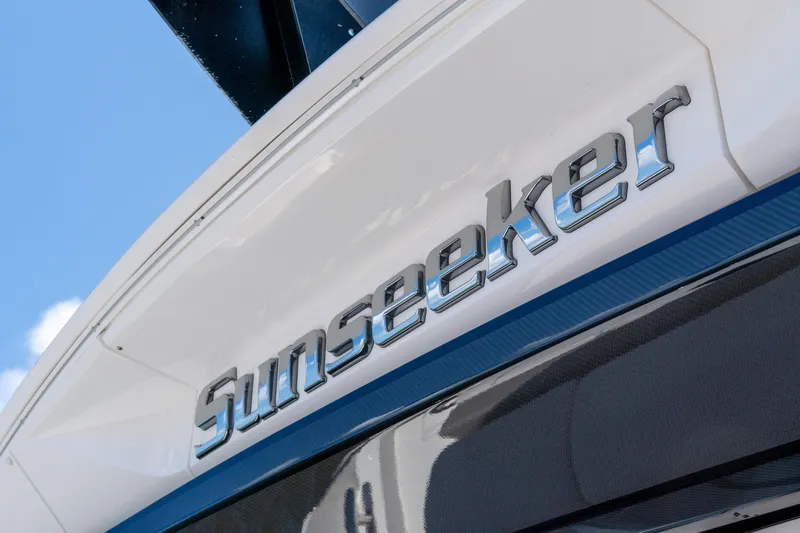 Brew Crew Yacht Photos Pics Sunseeker Predator 60 yacht logo, 2022 model, close-up view against blue sky.