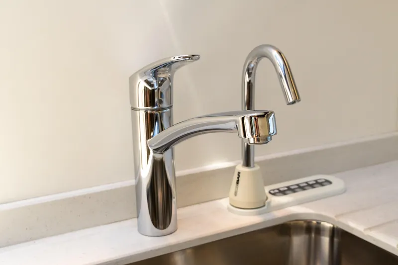 Brew Crew Yacht Photos Pics Modern chrome faucets in a Sunseeker Predator 60 yacht kitchen, 2022 model.