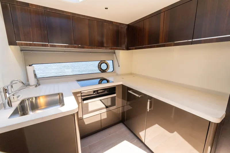 Brew Crew Yacht Photos Pics Luxurious kitchen interior of 2022 Sunseeker Predator 60 yacht with modern appliances.