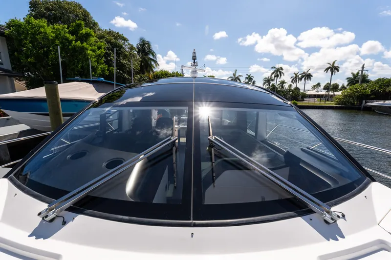 Brew Crew Yacht Photos Pics Sunseeker Predator 60 yacht, 2022 model, docked with sleek design and sunlit windows.